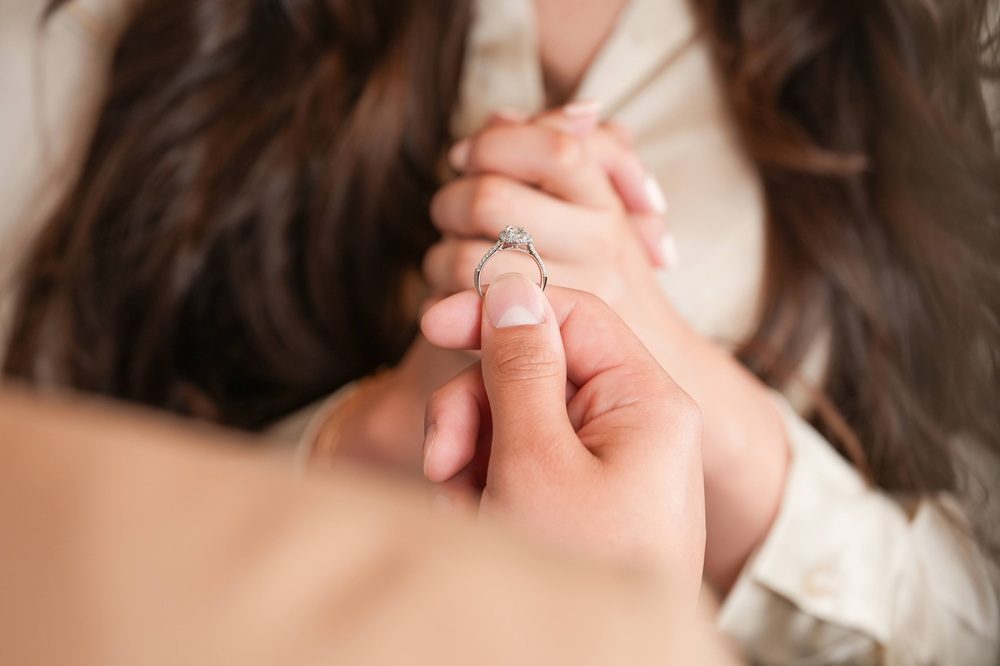 guy proposing with diamond engagement ring