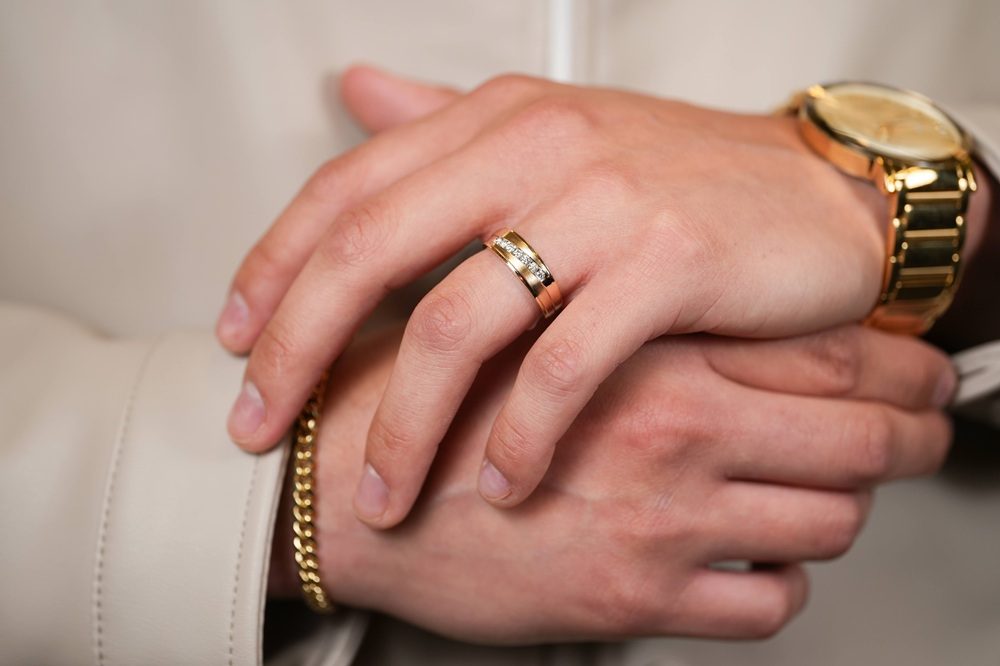 guy wearing men's jewelry including watch, diamond band and bracelet
